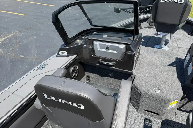 Slide: The Image of 2027 Lund 1875 Pro-V boat interior with gray seating and open windshield. - 5