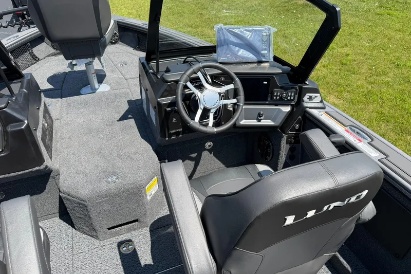 Slide: The Image of 2027 Lund 1875 Pro-V boat interior with steering wheel and seating. - 4