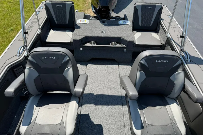 Slide: The Image of 2027 Lund 1875 Pro-V boat interior with four cushioned seats and carpeted flooring. - 13