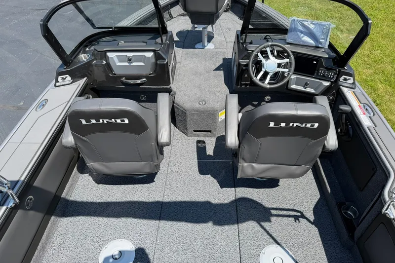 Slide: The Image of 2027 Lund 1875 Pro-V boat interior with dual seats and modern dashboard. - 3