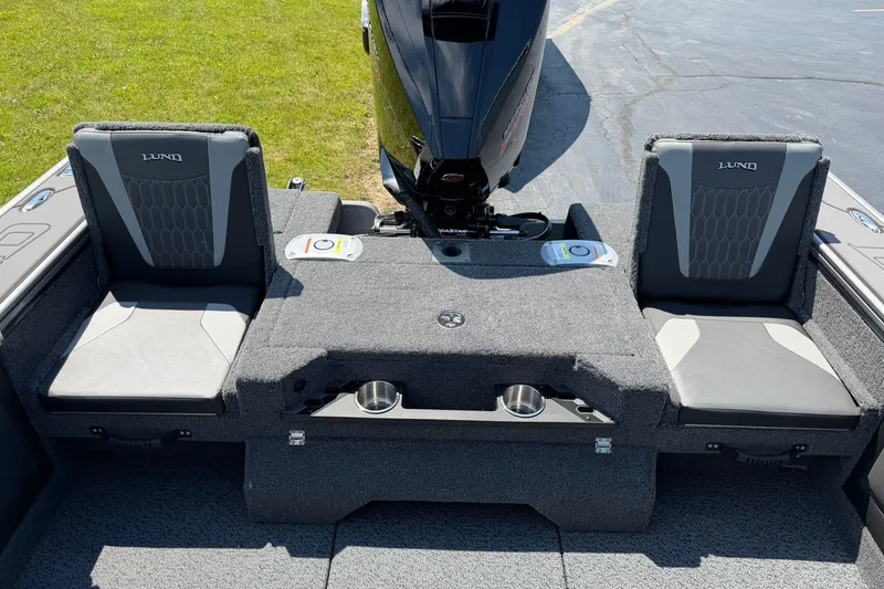 Slide: The Image of 2027 Lund 1875 Pro-V boat interior with seating and motor, showcasing modern design. - 6
