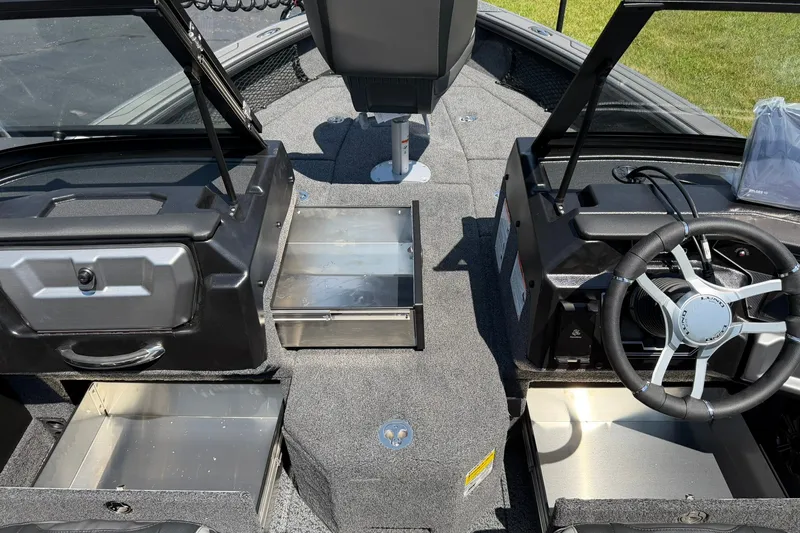 Slide: The Image of Interior view of a 2027 Lund 1875 Pro-V boat, featuring storage compartments and steering wheel. - 12