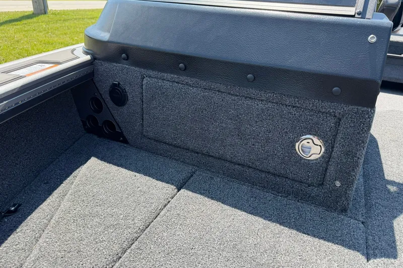 Slide: The Image of Interior view of 2027 Lund 1875 Pro-V boat, featuring carpeted storage compartment. - 19