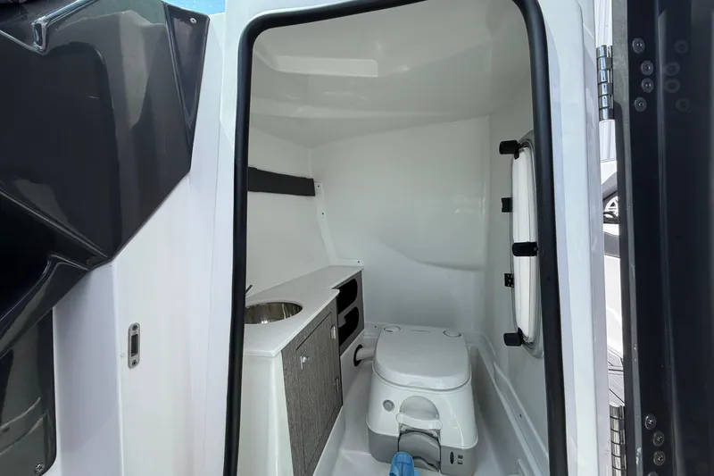 Slide: The Image of Interior of 2023 Monterey 258SS Super Sport boat bathroom with sink and toilet. - 18