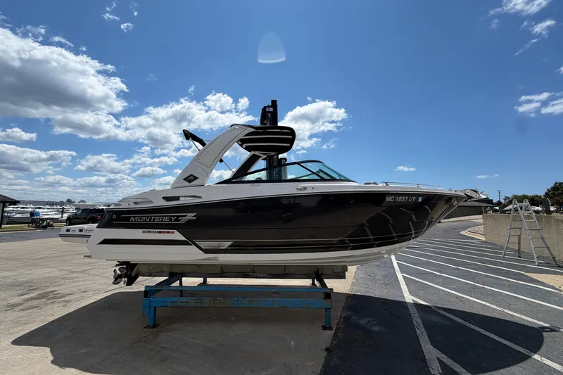 Slide: The Image of 2023 Monterey 258SS Super Sport boat on display under a clear blue sky. - 2