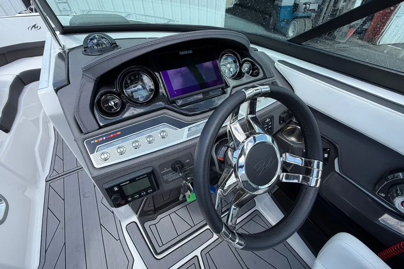 Slide: The Image of 2023 Monterey 258SS Super Sport boat dashboard with steering wheel and control panel. - 12