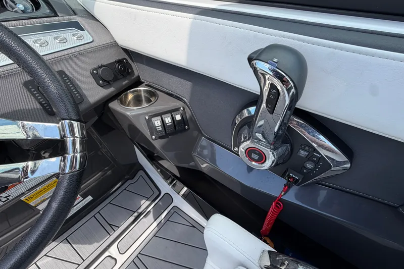 Slide: The Image of 2023 Monterey 258SS Super Sport boat cockpit with steering wheel and control panel. - 13