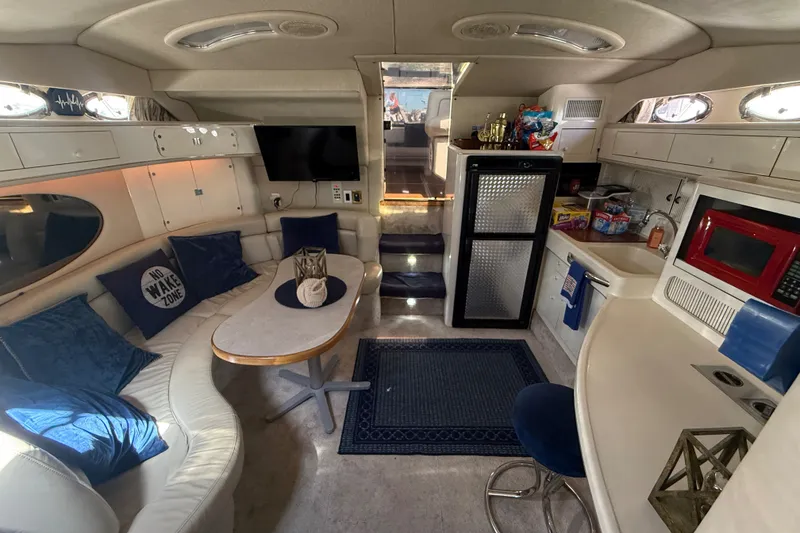 Slide: The Image of Interior of 1996 Sea Ray 400 Express Cruiser with cozy seating, kitchenette, and modern amenities. - 41
