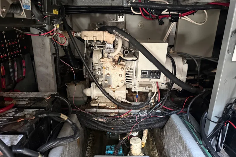 Slide: The Image of Engine compartment of a 1996 Sea Ray 400 Express Cruiser with visible wiring and components. - 45