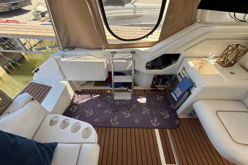 Slide: The Image of Interior of a 1996 Sea Ray 400 Express Cruiser with nautical-themed decor. - 14