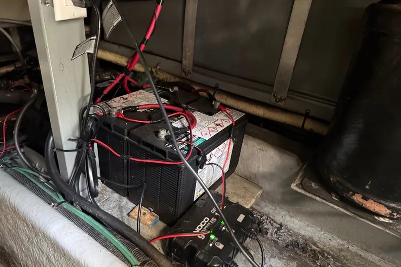 Slide: The Image of Battery setup in a 1996 Sea Ray 400 Express Cruiser engine compartment. - 48