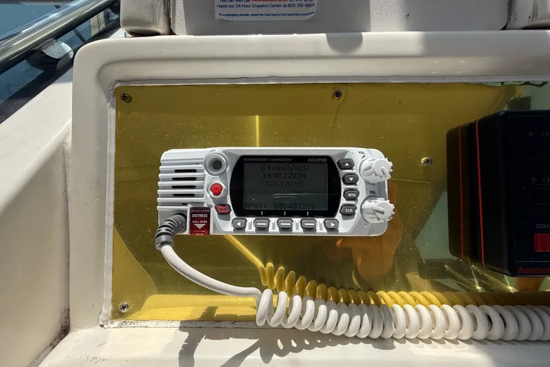Slide: The Image of VHF radio on 1996 Sea Ray 400 Express Cruiser dashboard, featuring Standard Horizon Eclipse model. - 23