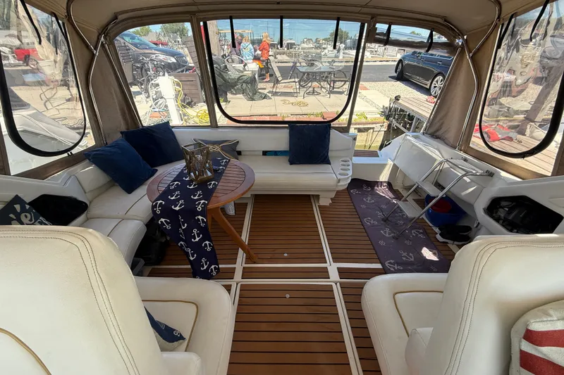 Slide: The Image of Interior of a 1996 Sea Ray 400 Express Cruiser with elegant seating and nautical decor. - 9