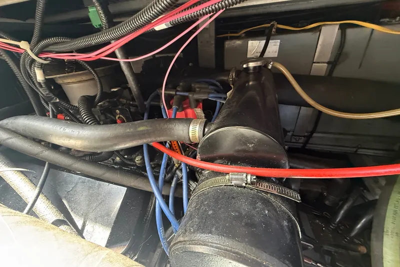 Slide: The Image of Engine compartment of a 1996 Sea Ray 400 Express Cruiser with visible wiring and hoses. - 47