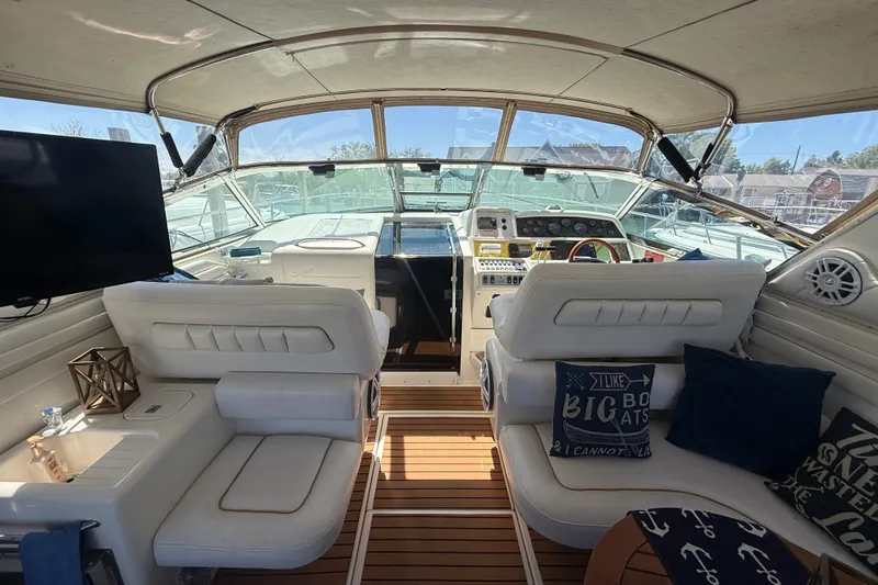 Slide: The Image of Interior of a 1996 Sea Ray 400 Express Cruiser with plush seating and modern amenities. - 13