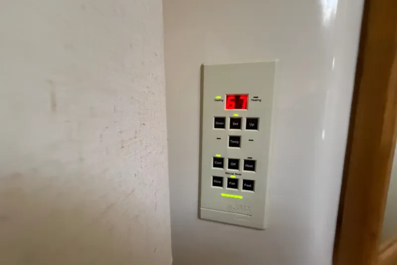 Slide: The Image of Control panel on a 1996 Sea Ray 400 Express Cruiser, displaying temperature settings. - 38