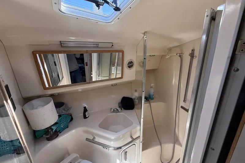 Slide: The Image of Bathroom interior of a 1996 Sea Ray 400 Express Cruiser with shower and sink. - 33