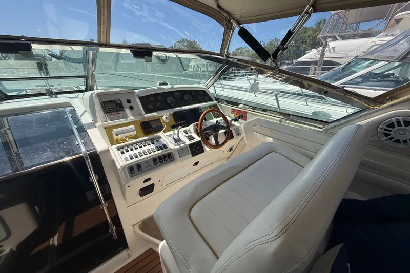 Slide: The Image of 1996 Sea Ray 400 Express Cruiser cockpit with steering wheel and control panel. - 17