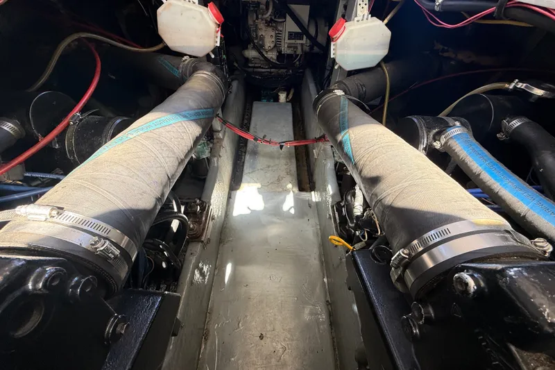 Slide: The Image of Engine compartment of a 1996 Sea Ray 400 Express Cruiser, showcasing hoses and components. - 44