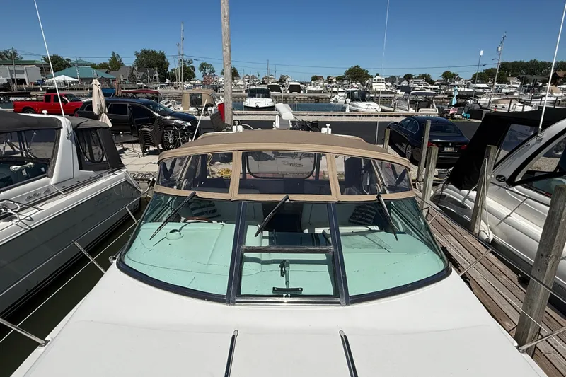 Slide: The Image of 1996 Sea Ray 400 Express Cruiser docked at a marina under clear blue skies. - 4