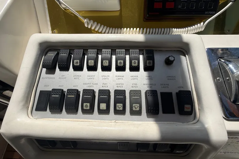 Slide: The Image of Control panel of a 1996 Sea Ray 400 Express Cruiser with various switches and labels. - 21