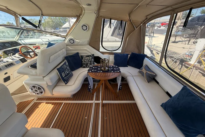 Slide: The Image of Interior of 1996 Sea Ray 400 Express Cruiser with plush seating and nautical decor. - 7