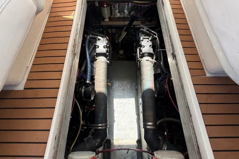 Slide: The Image of The engine compartment of a 1996 Sea Ray 400 Express Cruiser shows two engines and wiring. - 42