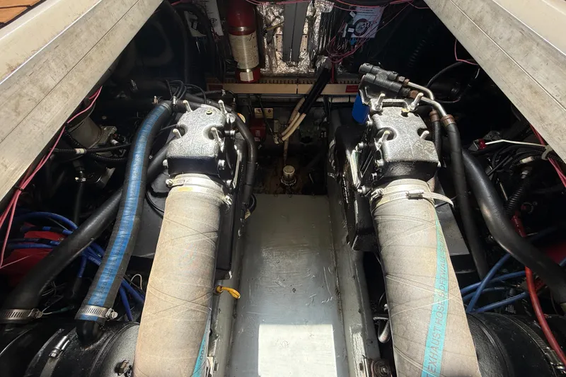 Slide: The Image of Engine compartment of a 1996 Sea Ray 400 Express Cruiser, showcasing dual engines and components. - 43