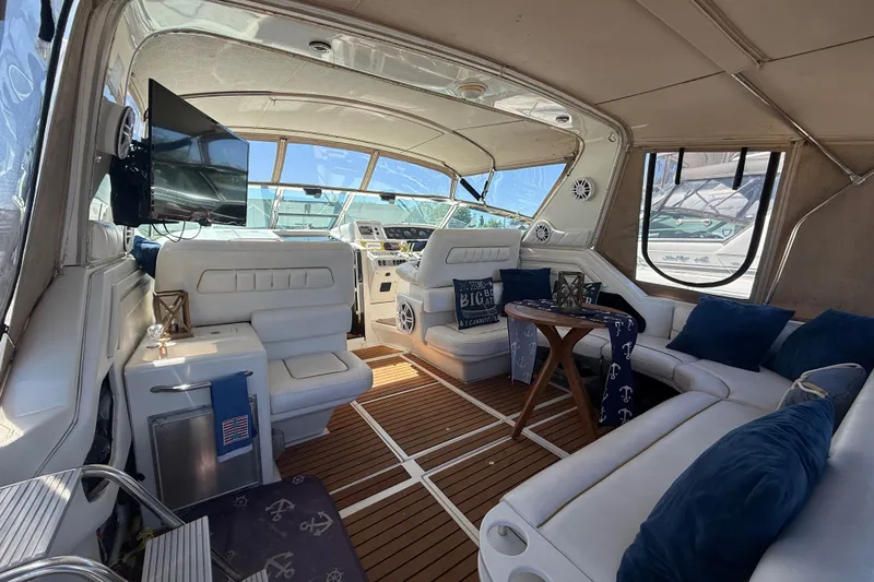 Slide: The Image of Luxurious interior of a 1996 Sea Ray 400 Express Cruiser with plush seating and modern amenities. - 6