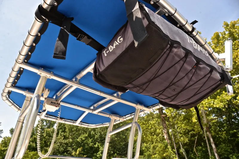 Slide: The Image of 2019 NauticStar 215 XTS Shallow Bay boat with T-top storage bag and blue canopy. - 25