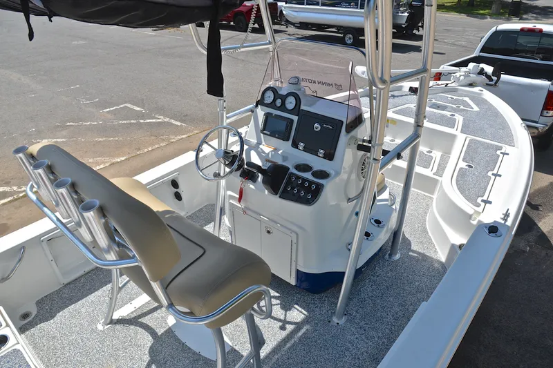 Slide: The Image of 2019 NauticStar 215 XTS Shallow Bay boat interior with steering console and seating. - 18