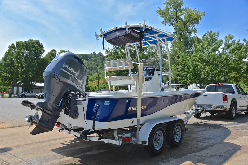 Slide: The Image of 2019 NauticStar 215 XTS Shallow Bay boat on trailer with Yamaha engine. - 14