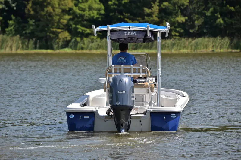 Slide: The Image of 2019 NauticStar 215 XTS Shallow Bay boat cruising on a calm lake. - 8