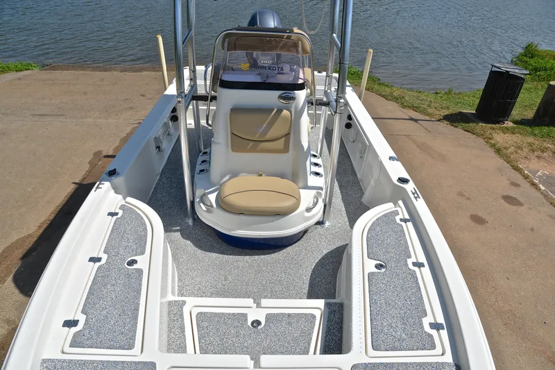 Slide: The Image of 2019 NauticStar 215 XTS Shallow Bay boat interior at a lakeside dock. - 21