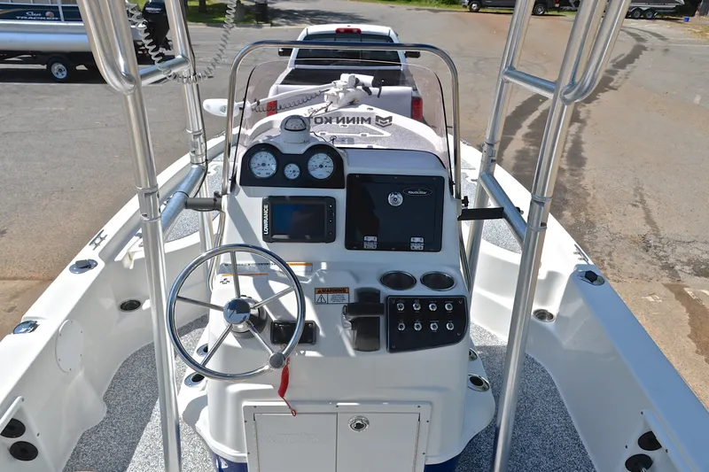 Slide: The Image of 2019 NauticStar 215 XTS Shallow Bay boat dashboard with steering wheel and controls. - 24