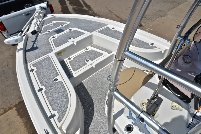 Slide: The Image of 2019 NauticStar 215 XTS Shallow Bay boat deck with storage compartments and trolling motor. - 19