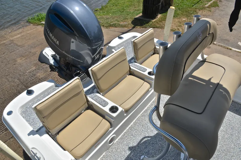 Slide: The Image of 2019 NauticStar 215 XTS Shallow Bay boat interior with Yamaha engine, featuring beige seating. - 23