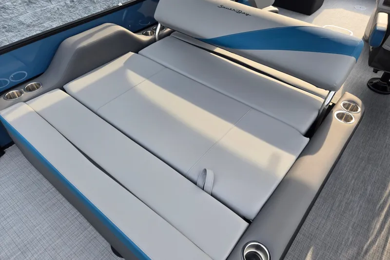 Slide: The Image of The image shows a luxurious lounging area on a boat with gray and blue upholstery. - 11