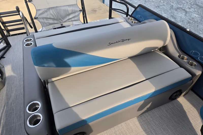 Slide: The Image of The 2027 South Bay SS224UL3.0 features a stylish cushioned bench with blue accents and cup holders. - 8