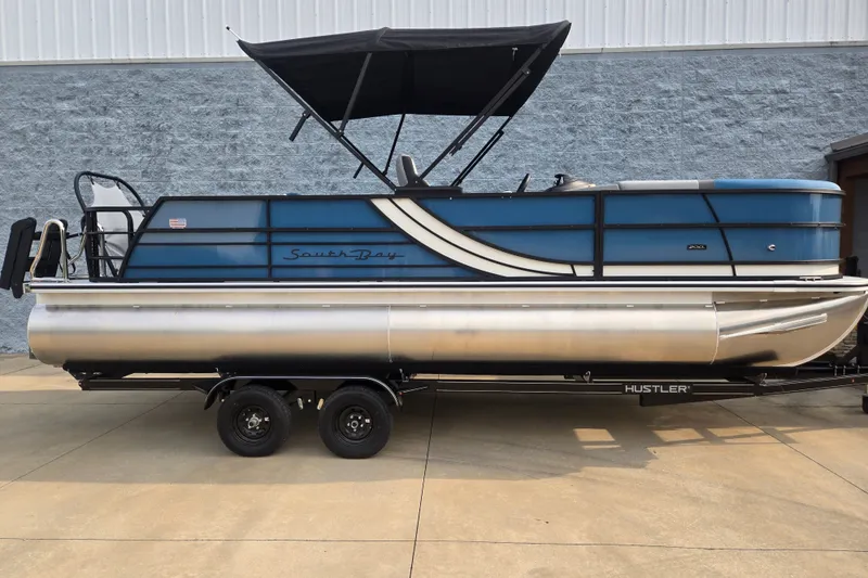 The Image of A 2027 South Bay SS224UL3.0 pontoon boat with a blue hull and black sunshade. - 1