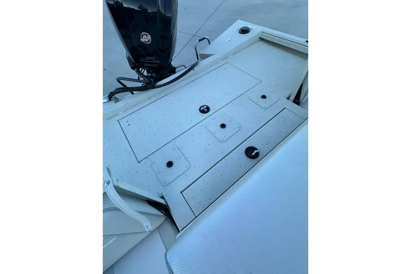 Slide: The Image of 2024 Ranger RB190 Bay boat deck with storage compartments and motor. - 17