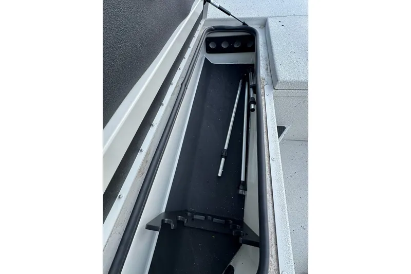 Slide: The Image of Storage compartment of 2024 Ranger RB190 Bay boat with rods and accessories. - 19