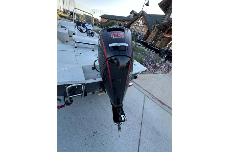 Slide: The Image of 2024 Ranger RB190 Bay boat with Mercury 115 outboard motor, parked near a building. - 8