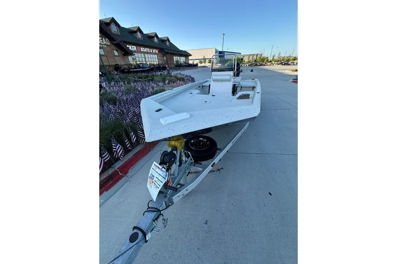 Slide: The Image of 2024 Ranger RB190 Bay boat on trailer outside a dealership. - 2
