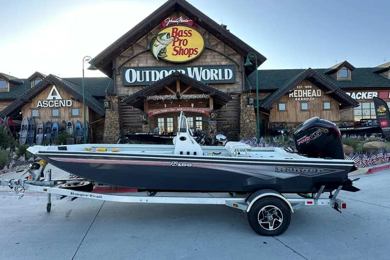 The Image of 2024 Ranger RB190 Bay boat on trailer outside Bass Pro Shops Outdoor World. - 1
