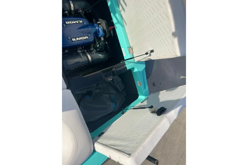Slide: The Image of 2018 MasterCraft XT23 boat engine compartment with Ilmor engine, open storage area. - 14