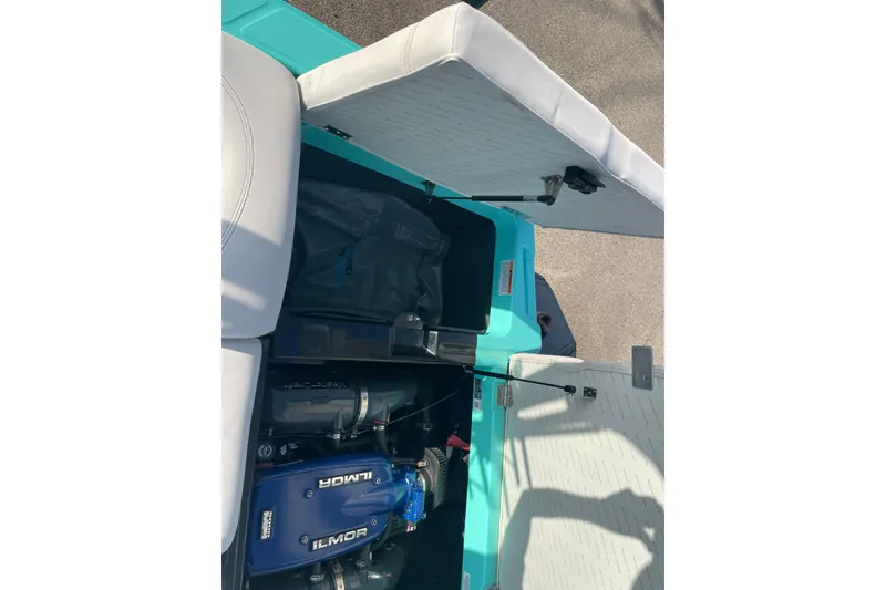 Slide: The Image of 2018 MasterCraft XT23 boat engine compartment with Ilmor engine visible. - 13