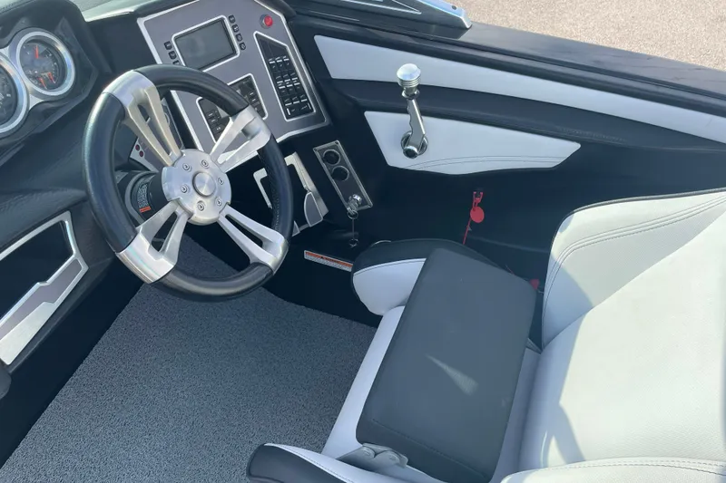 Slide: The Image of 2018 MasterCraft XT23 boat interior with steering wheel and control panel. - 18