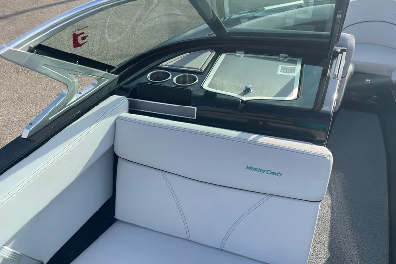 Slide: The Image of Interior of a 2018 MasterCraft XT23 boat with white seating and cup holders. - 9