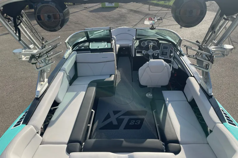 Slide: The Image of 2018 MasterCraft XT23 boat interior with sleek seating and advanced dashboard controls. - 7